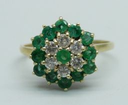 A 9ct gold, emerald and diamond cluster ring, 13 emeralds and 6 diamonds, R, 2.9g, Birmingham 1988