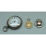 A silver pocket watch, 4cm case, and two gold fronted silver fob medals