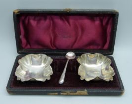 A pair of silver salts, Birmingham 1897, cased, and one silver salt spoon, 32g