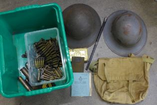 A box of Army related items including two WWII helmets, 1914 Christmas tin, WWII bronze plaque,