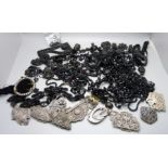 A collection of jet jewellery, a horse hair chain, buckles, etc.