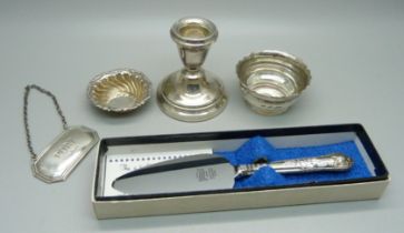 Five silver items; Port label, two salts, candlestick and small silver handled server, weighable
