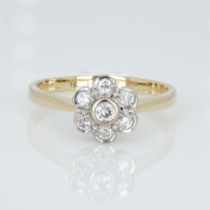 An 18ct gold and diamond cluster ring, 0.33ct diamond weight marked on the shank, ring size R½,