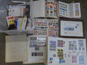 A box containing stamp albums, loose stamps and twenty Royal Mail mint stamp packs