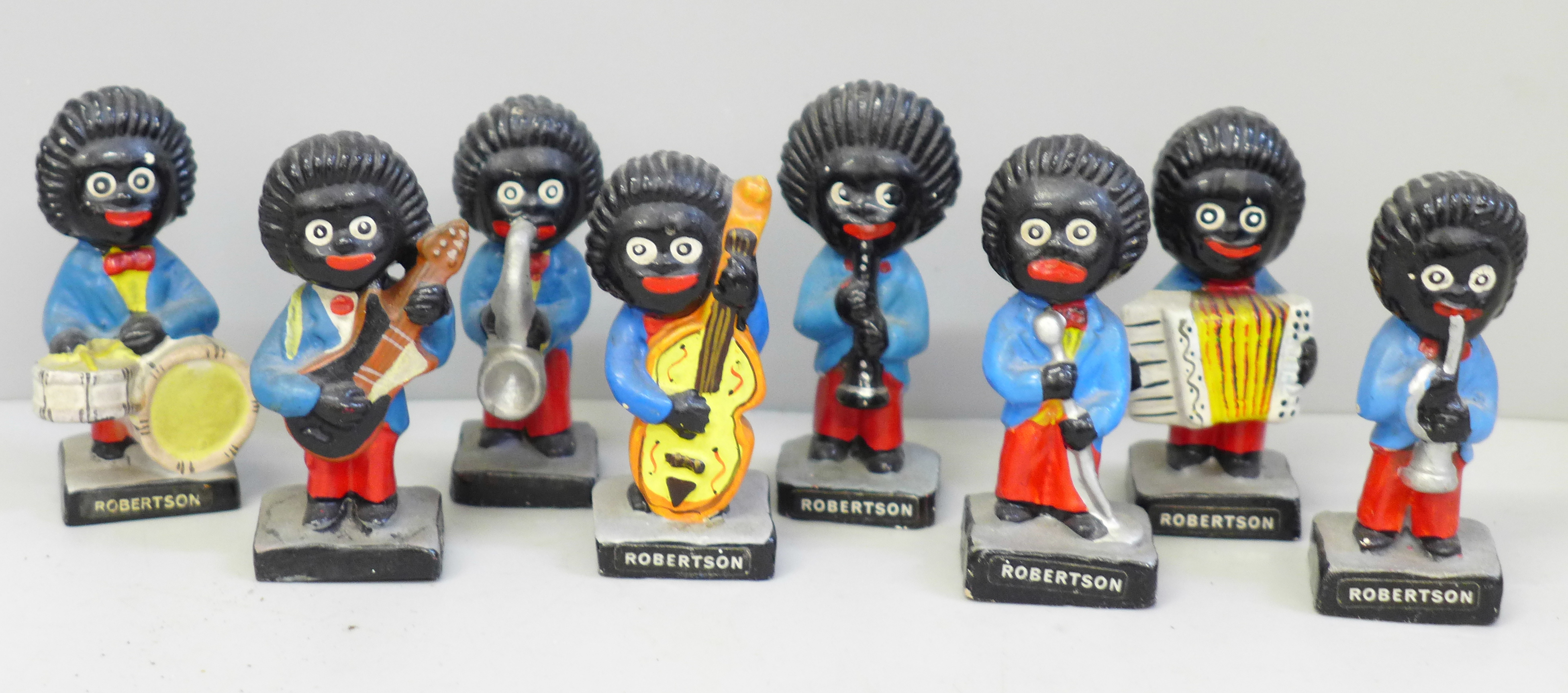 Eight Robertsons advertising figures, (These items are listed on the basis they are illustrative