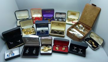 A large collection of cufflinks and tie-pins