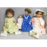 A box of four vintage and modern dolls