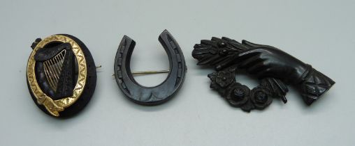 A c1900 bog oak Irish harp brooch and two other brooches