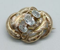 A yellow metal and aquamarine brooch also set with small diamonds, 3.2g