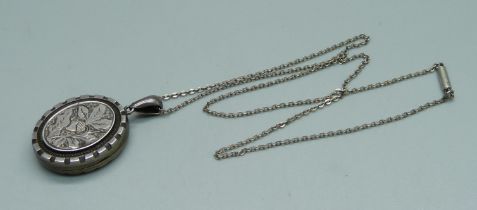 A Victorian silver engraved locket on a silver chain, Birmingham 1882, 21mm wide