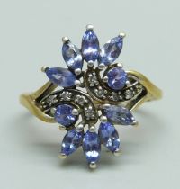 A tanzanite and diamond cocktail cluster ring, marked 9K, 3.4g, O/P