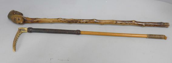 A 19th Century hawthorn walking cane, with carved hunting related top and a riding crop with