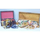 A collection of bead necklaces in two wooden boxes
