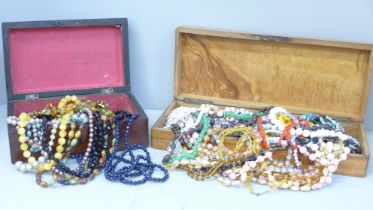 A collection of bead necklaces in two wooden boxes