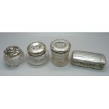 Four silver top glass jars