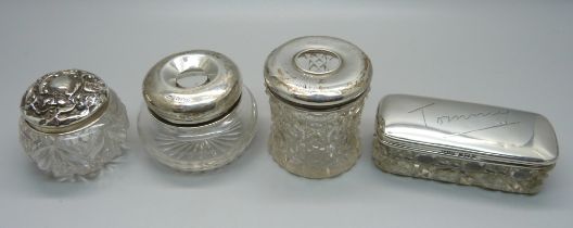 Four silver top glass jars