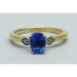 A silver gilt and blue stone ring set with two small diamonds, N