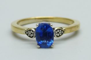 A silver gilt and blue stone ring set with two small diamonds, N
