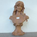 An Art Nouveau style faux terracotta bust of a lady