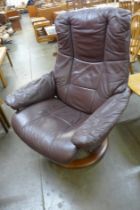 An Ekorness beech and brown leather Stressless revolving lounge chair