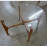 A teak and glass topped oval coffee table