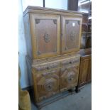 An early 20th Century Jacobean Revival carved oak cocktail cabinet