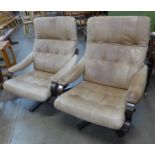 A pair of Scandinavian bent beech wood and leather revolving lounge chairs. Please note this lot