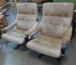 A pair of Scandinavian bent beech wood and leather revolving lounge chairs. Please note this lot
