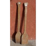 A pair of vintage wooden paddles