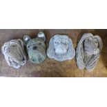 Four assorted concrete wall mounted garden dog's heads