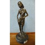 A bronze figure of a lady in a negligee