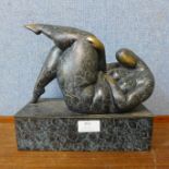 An abstract bronze figure of a reclining nude female