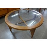 A Stonehill Stateroom teak and glass topped circular coffee table