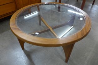 A Stonehill Stateroom teak and glass topped circular coffee table