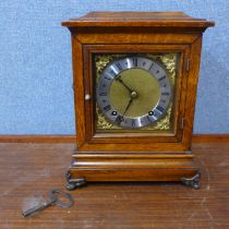 An early 20th Century carved oak mantel clock, marked Hitchcock & Son, Market Place, Bingham