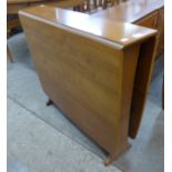 A teak drop-leaf table