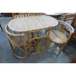 A bamboo and rattan table and two chairs