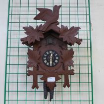 A West German carved wood effect cuckoo clock