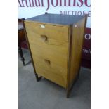 A teak chest of drawers