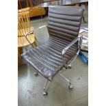 An Eames style chrome and brown leather revolving desk chair