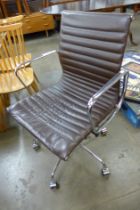 An Eames style chrome and brown leather revolving desk chair