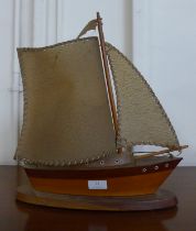 A teak boat shaped table lamp
