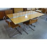A teak and chrome dining table and four chrome and brown faux cantilever chairs