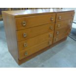 A pair of teak small teak chests of drawers