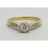 An 18ct gold and diamond solitaire ring with diamond shoulders, 0.3ct diamond weight, 3.6g, O