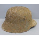 A WWI battle damaged German helmet
