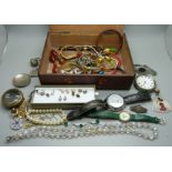 A box of costume jewellery, wristwatches, brass watch case and vesta