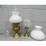 A paraffin lamp, a candle lamp and a glass chimney and shade **PLEASE NOTE THIS LOT IS NOT