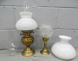 A paraffin lamp, a candle lamp and a glass chimney and shade **PLEASE NOTE THIS LOT IS NOT