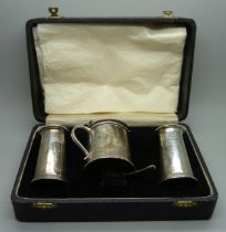 A set of Viners silver condiments; mustard, salt and pepper pots and a mustard spoon, 240g, cased
